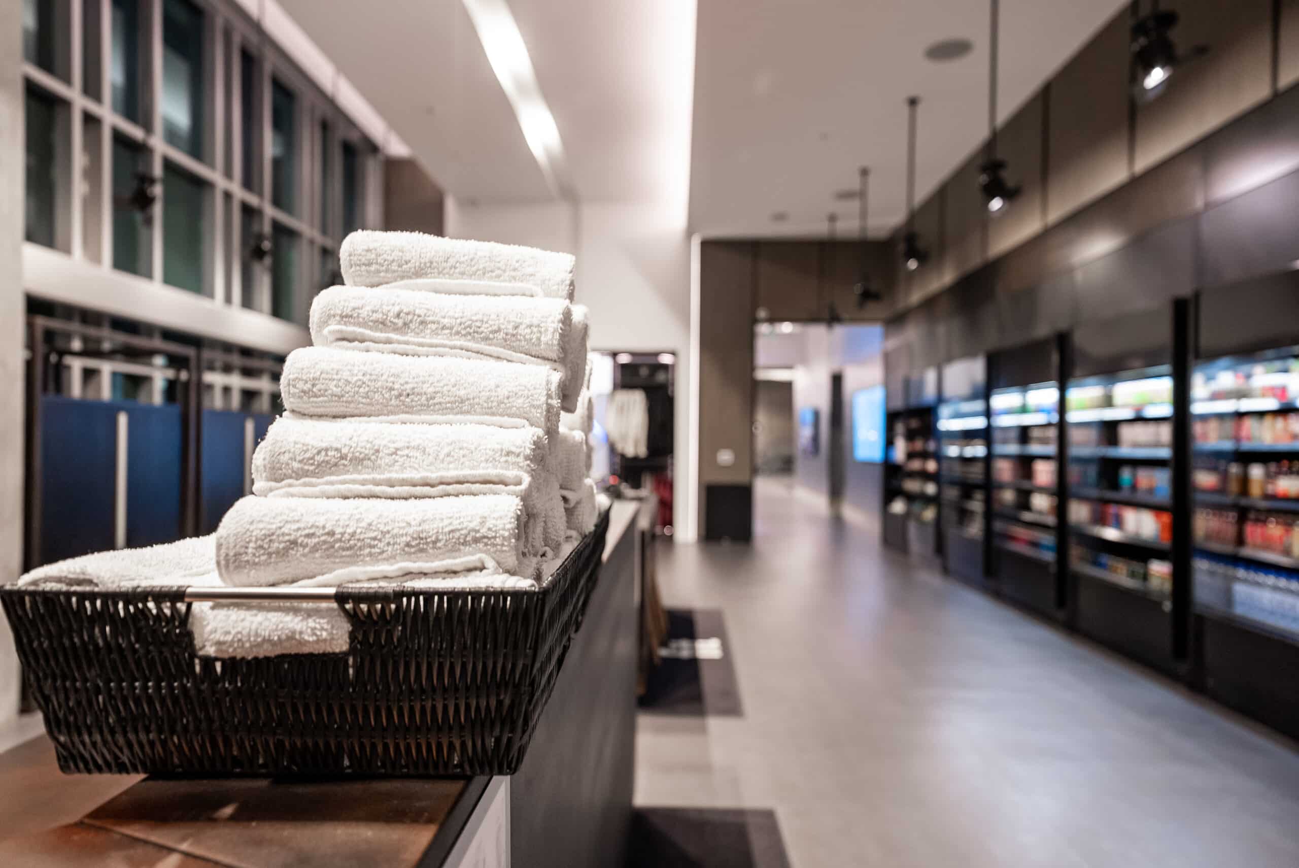 A basket of towels on a shelf in a store.