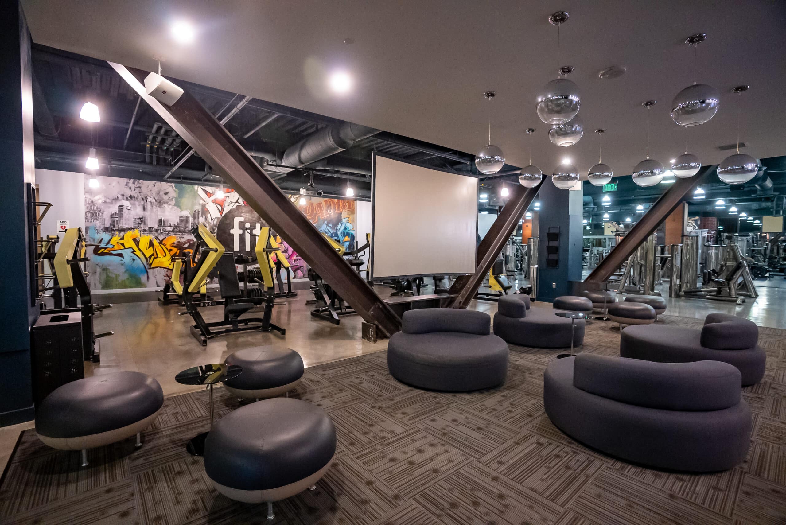 A gym with a large group of people in it.