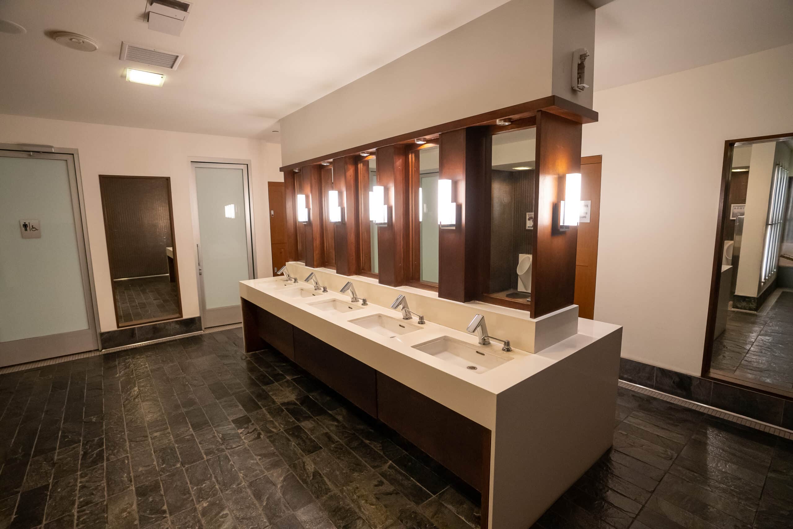 A large bathroom with sinks and mirrors.